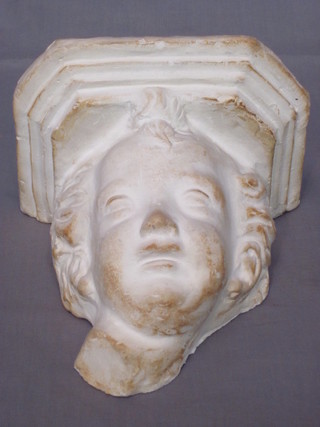 A plaster wall bracket in the form of a cherubs head 7"