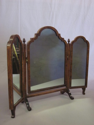 A triple plate dressing table mirror contained in a walnut frame