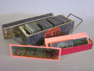 A box containing various black and white photographic slides and a collection of humerous coloured magic lantern slides