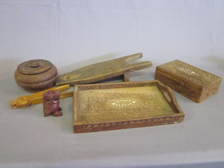 A wooden boot jack, a carved wooden Eastern twin handled tray,  a pair of wooden nut crackers and other wooden items etc