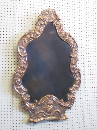 A 19th Century Dutch style shaped plate mirror contained in an embossed brass frame with floral decoration 29"