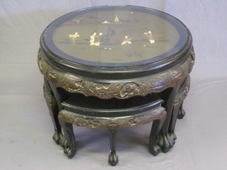 A circular Oriental lacquered occasional table the top inlaid figures of Geishas, the base fitted 4 triangular shaped tables,  raised on carved supports 28"