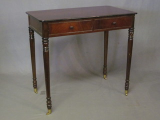 A 19th Century mahogany side table fitted 2 long drawers, raised  on turned supports 36"