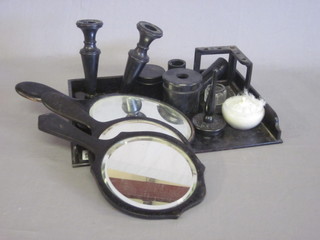 A 13 piece ebonised dressing table set comprising tray, 3 hand mirrors, shoe horn, pair of glove stretchers, pair of candlesticks,  ring stand, hair tidy, 3 jars and 1 other ebonised item