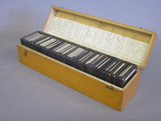 A wooden box containing a collection of black and white  photographic slides