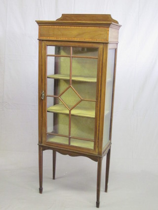 An Edwardian inlaid mahogany display cabinet with raised back,  the interior fitted shelves enclosed by astragal glazed panelled  door, raised on square tapering supports ending in spade feet 24"
