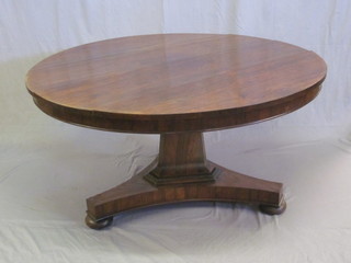 A circular William IV rosewood snap top breakfast table, raised on a chamfered column with triform base 54", split to top,