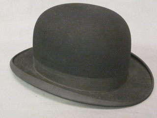 A brown hat box containing a gentleman's light weight bowler  hat by Dunn & Co