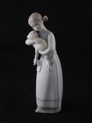An early Lladro figure of a standing girl with lamb, the base  marked Lladro 8 1/2"  ILLUSTRATED