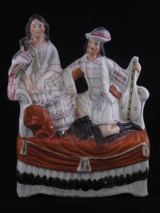 A Staffordshire figure group of a kneeling Scotsman and lady  with parrot 10"