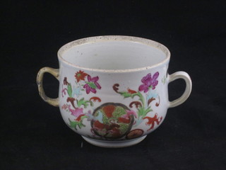 A famille rose porcelain twin handled cup with floral decoration  4", handle f and r,