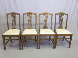 A set of 4 Hepplewhite style mahogany camel back dining chairs  with upholstered drop in seats, raised on square tapering supports