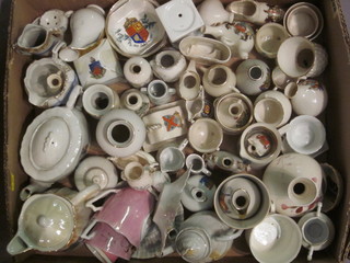 A cardboard box containing a collection of crested china