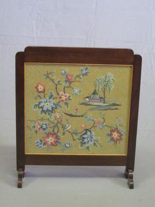 A 1930's rectangular mahogany fire screen with Berlin woolwork panel to the centre 23"