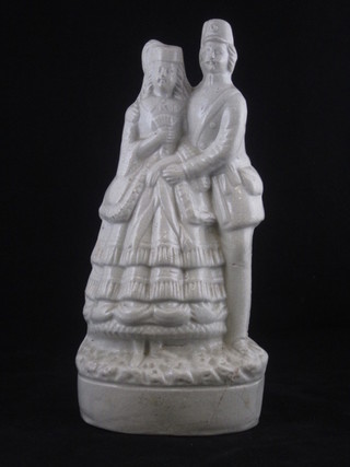 A white glazed Staffordshire figure group of a soldier and lady  11", f and r,