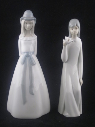 A Spanish porcelain figure of a standing lady 9" and 1 other with dove 8"