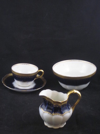 A 43 piece Limoges blue and gilt banded tea service comprising  4 9 1/2" circular twin handled dishes, 12 7 1/2" plates - 2 with  chips, 12 cups and 12 saucers - 1 saucer chipped and 1 cup  cracked, 2 cream jugs and a sugar bowl,