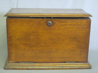 A Victorian honey oak stationery box with hinged lid incorporating a writing slope 17"