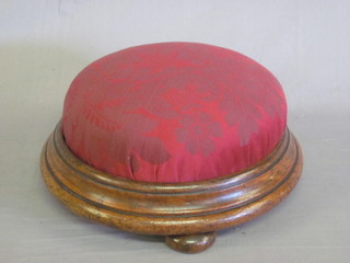 A Victorian circular turned mahogany footstool, raised on 3 bun  feet upholstered in red material 13"