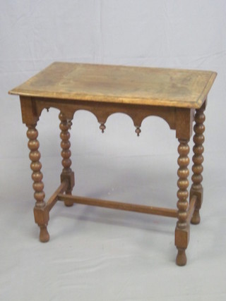 A Victorian rectangular oak Gothic style side table with wavy  apron, raised on ring turned supports with H framed stretcher 29"