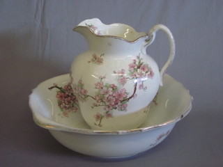 A pottery jug and bowl with floral decoration