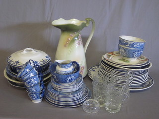 A green glazed Art Nouveau pottery jug 12", a glass jug and a collection of blue and white table china
