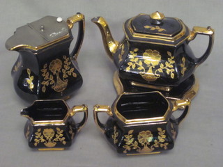 A 19th Century 5 piece black and gilt glazed tea service  comprising teapot, teapot stand, twin handled sugar bowl, cream  jug and hotwater jug