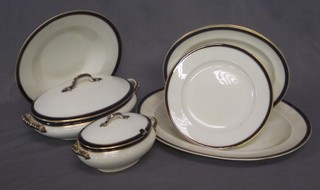 A 31 piece Stoke China blue and white patterned dinner service  with blue and gilt banding comprising 2 11" oval tureens and  covers - 1 f, a 15" oval meat plate, 2 10 1/2" oval meat plates,  twin handled sauce tureen and cover 6", 9 10" dinner plates, 6  10" soup bowls and 10 9" side plates - all cracked except 1  tureen and 2 soup bowls, together with 5 cut glass crescent  shaped salad dishes, a tea bowl, 2 boat shaped dishes etc,