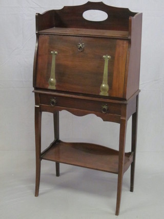 An Edwardian Art Nouveau mahogany students bureau with  three-quarter gallery, fitted a fall front revealing a fitted interior  above 1 long drawer, the base fitted an undertier 23"