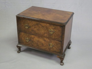 A walnut chest of 2 long drawers, raised on cabriole supports 30"