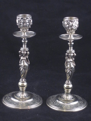 A pair of silver plated candlesticks decorated classical ladies, 7"
