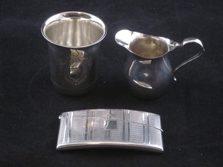 A silver card case with engine turned decoration Birmingham  1928, a small silver cream jug Birmingham 1922 and a Continental beaker