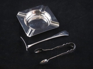 A square silver ashtray Birmingham 1944, a childs silver pusher and a pair of sugar tongs, 3 ozs