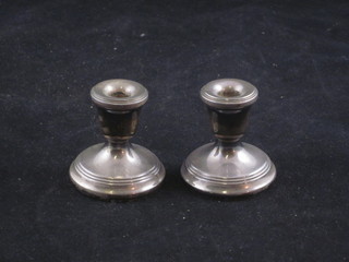 A pair of white metal stub shaped candlesticks 1 1/2"