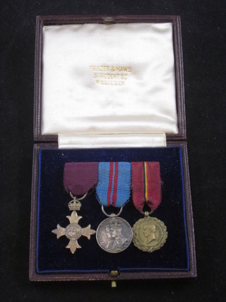 A group of 3 miniature medals comprising OBE Civil Division  First Type, George V Delhi Durbar medal and The Belgian  medal of King Albert, contained in a leather case