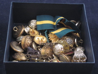 A Royal Fusiliers officer's cap badge and a collection of buttons, pips etc