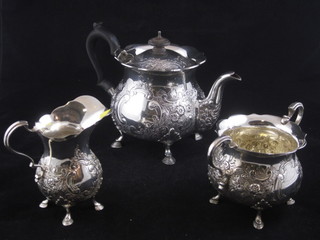An Edwardian circular embossed silver 3 piece tea service  comprising teapot, twin handled bowl and milk jug, London  1903, 37ozs
