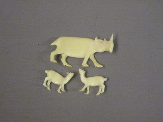 A carved ivory figure of a rhinoceros 4" and 2 other small ivory figures of animals 1"