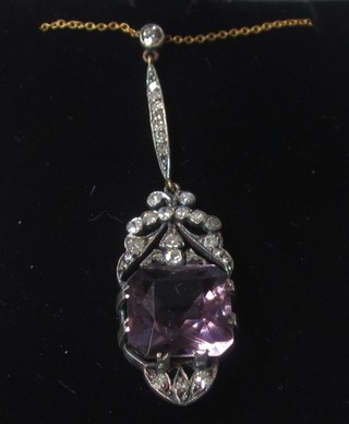 A Victorian style amethyst pendant supported by diamonds