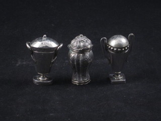 2 Continental white metal twin handled urns and covers 1 1/2"  and a Continental embossed silver jar and cover 2"
