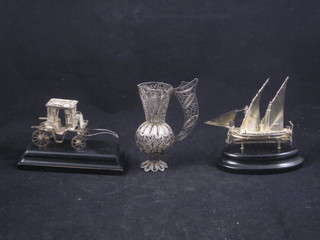 A silver filigree jug 4" and a silver filigree model of a carriage  and 1 other of a boat