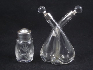 An oil and water bottle with silver collar, cracked, a cut glass pepperette with silver mount