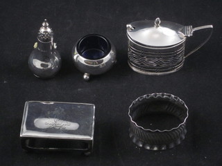 A boat shaped pierced silver mustard pot with blue glass liner, a circular silver salt, pepperette, napkin ring and a match slip