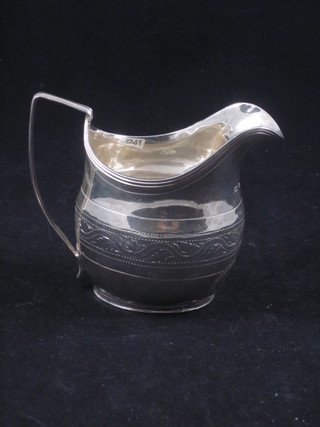 A George III silver cream jug with bright cut decoration, London 1806, 2 ozs