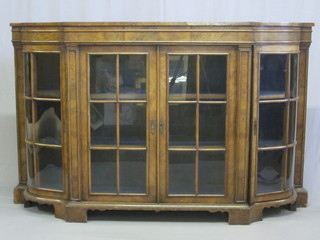 A figured walnut Credenza with shelved interior enclosed by astragal glazed panelled doors, raised on bracket feet 68"