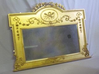 A Victorian rectangular bevelled plate over mantel mirror  contained in an arched gilt plaster frame 54"   ILLUSTRATED
