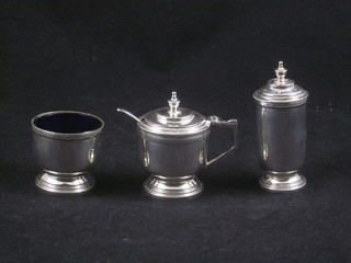 A 3 piece silver condiment set of cylindrical form comprising  mustard, pepper and salt pot, Sheffield 1938, 4 ozs