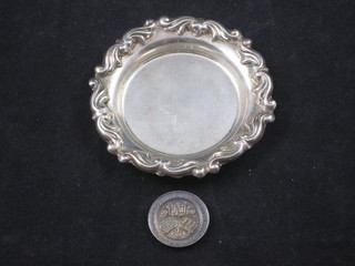 A small circular silver dish 3" and a silver spinning medal