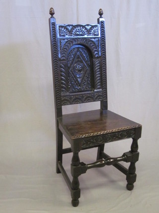 A Victorian ebonised oak hall chair with carved back and solid  seat, raised on turned and block supports