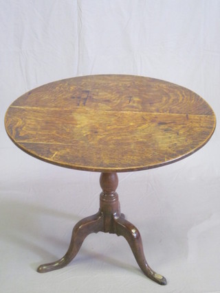 An 18th/19th Century circular oak snap top tea table, raised on pillar and tripod base, old repair to base, 29"